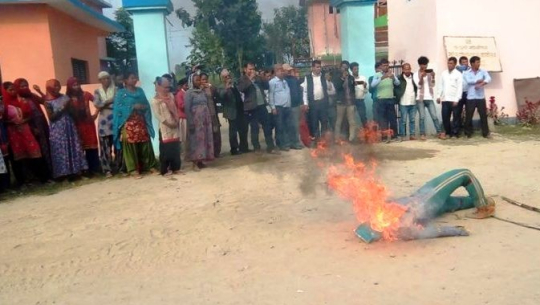 An effigy of Madansen Badayak burnt outside his office