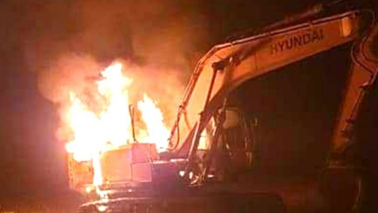 An unidentified group sets fire to a crain in Kailali.